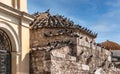 Many pigeons on church roof.