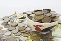 Many Pile of coins baht Thailand currency in yellow ceramic bowl.