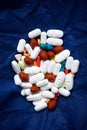 Many pills on a blue fabric Royalty Free Stock Photo