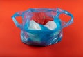 Many Plastic Bags on Red Background. Crumpled Plastic Bag after Shopping, Cellophane Packaging Waste