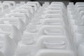 Rows of white plastic canisters ready to be filled with chemicals