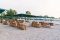 Many plastic deckchairs and umbrellas at the sea beach at sunrise. Summer vacation concept. Royalty Free Stock Photo