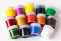 Many plastic jars with gouache or acrylic paints top view on a light background. Selective soft fokus. Text copy space Royalty Free Stock Photo