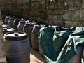 Many plastic wine barrels near a stone wall Royalty Free Stock Photo