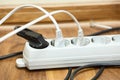 Many plugs plugged into electric power bar Royalty Free Stock Photo