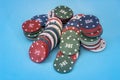 Many poker chips isolated on blue Royalty Free Stock Photo