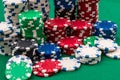 Many poker chips isolated on a green background Royalty Free Stock Photo