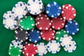 Many poker chips isolated on a green background Royalty Free Stock Photo