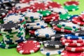 Many poker chips isolated on a green background Royalty Free Stock Photo