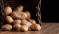 Potatoes garlic carrot vegetable still life raw food wicker basket rustic wooden floor Royalty Free Stock Photo