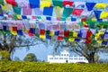 Many prayer flags in the wind against the Holy Maya Devi Temple in Lumbini, Nepal Royalty Free Stock Photo