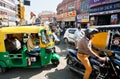 Many private yellow-green rickshaw cabs and cars