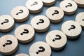 Many question marks on round wood blocks arranged in the rows, many questions need the answers, system, processing, test, or FAQS