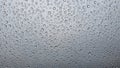 Many rain drops on glass on light gray white background creating abstract pattern with water droplets and smooth clean surface Royalty Free Stock Photo