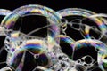 Many rainbow bubbles on a black background. Abstract detail Royalty Free Stock Photo