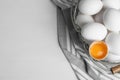 Many raw chicken eggs in metal basket on  wooden table, flat lay. Space for text Royalty Free Stock Photo