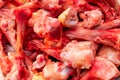 Many raw chopped gnawed chicken bones in heap lie on the table. Eating poor people or eating for dogs. Selective focus. Close-up