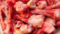 Many raw chopped gnawed chicken bones in heap lie on the table. Eating poor people or eating for dogs. Selective focus. Close-up