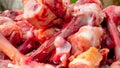 Many raw chopped gnawed chicken bones in heap lie on the table. Eating poor people or eating for dogs. Selective focus. Close-up
