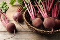 Many raw ripe beets on wooden table