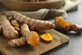 Many raw turmeric roots on grey table, closeup Royalty Free Stock Photo