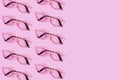 Many reading glasses on pink background pattern Royalty Free Stock Photo