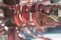 Many red aged metal locks in the shape of a heart on the ralling on a sunny day, close-up, soft light, blurred background Royalty Free Stock Photo