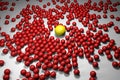 Many red balls among which the yellow one stands out Royalty Free Stock Photo