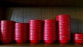 Many red bowl putting or sort on wooden shelf at Chinese restaurant.