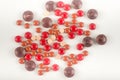 Many red  brown pills on a white background. Different size of sphere drugs splatter on background Royalty Free Stock Photo