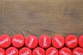 Many red caps with coca cola logo on wooden background Royalty Free Stock Photo
