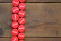 Many red caps with coca cola logo on wooden background Royalty Free Stock Photo