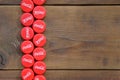 Many red caps with coca cola logo on wooden background Royalty Free Stock Photo