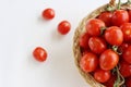 Many red cherry tomatoes with sepals in the basket isolated on the white background. Tomato pile. Ripe and fresh organic Royalty Free Stock Photo