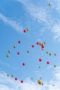 Many red and gold balloons fly under the blue sky and white clouds Royalty Free Stock Photo