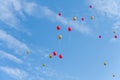 Many red and gold balloons fly under the blue sky and white clouds Royalty Free Stock Photo