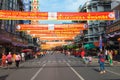 Many Red and Gold Bannners Strung across a Street to Commemorate