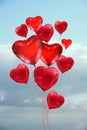 Many red heart shaped balloons before blue sky. Valentine \'s day celebration Royalty Free Stock Photo