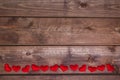 Many red heart on wooden background