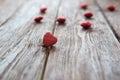 Many red hearts on a wooden background