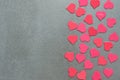 Many red and pink hearts on a grey concrete background.Valentine`s day. Royalty Free Stock Photo