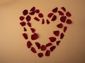 Many red rose petals lie in the shape of a large red heart Royalty Free Stock Photo