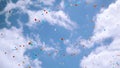 Many red, white, blue air balloons fly in beautiful cloudness sky. Colors of national Russian flag