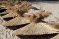 Many reed umbrellas on the pile on the beach in spring