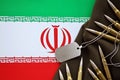 Many rifle bullets and dog tags with flag of Islamic Republic of Iran. The concept assault and terrorism Royalty Free Stock Photo