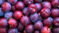 Many ripe plums with leaves at local market. Generative AI Royalty Free Stock Photo