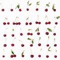 Many ripe red cherries arranged on white