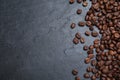 Many roasted coffee beans on black table, flat lay. Space for text