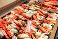 Many roasted king crab legs and claws with name and label price