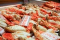 Many roasted king crab legs and claws with name and label price